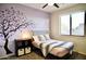 Charming bedroom featuring a purple accent wall and a comfortable bed at 4454 S Lariat Ct, Gilbert, AZ 85297