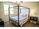 Bright bedroom with a modern four poster bed and ample natural light at 4454 S Lariat Ct, Gilbert, AZ 85297