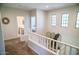 Upstairs hallway features carpet, lots of light, and views to the downstairs at 4454 S Lariat Ct, Gilbert, AZ 85297