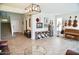 Open-concept living room with stylish chandelier, decorative furniture, and staircase at 4454 S Lariat Ct, Gilbert, AZ 85297