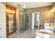 Luxurious bathroom featuring a modern shower and bathtub with wood accent wall at 4454 S Lariat Ct, Gilbert, AZ 85297