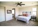 Spacious main bedroom with a ceiling fan and view to the ensuite bathroom at 4454 S Lariat Ct, Gilbert, AZ 85297