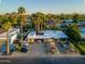 Stunning aerial view of a modern home with palm trees, desert landscaping, and a multi-car driveway at 5311 E Mitchell Dr, Phoenix, AZ 85018