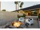 Inviting outdoor space with a cozy fire pit, modern patio chairs, and open access to the home at 5311 E Mitchell Dr, Phoenix, AZ 85018