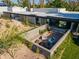 A landscaped backyard patio with an outdoor fire pit offers a charming seating area perfect for relaxation at 5311 E Mitchell Dr, Phoenix, AZ 85018