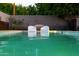 Refreshing backyard pool with lounge chairs, complemented by lush landscaping and a serene atmosphere at 5311 E Mitchell Dr, Phoenix, AZ 85018
