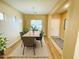 Sunlit dining room features modern table and chairs, wood floors, and seamless flow to other rooms at 5743 W Gwen St, Laveen, AZ 85339