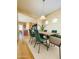 Dining area features a wooden table with seating for six, plus an eye-catching light fixture at 5743 W Gwen St, Laveen, AZ 85339