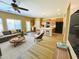 Bright living area with wood flooring, a ceiling fan, and an open layout connected to the kitchen at 5743 W Gwen St, Laveen, AZ 85339
