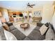 Open-concept living room showcasing wood floors, modern furnishings, and seamless flow to the kitchen at 5743 W Gwen St, Laveen, AZ 85339