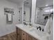 Well-lit bathroom with double sinks, neutral decor, and a clean, modern design at 6607 S Mitchell Dr, Tempe, AZ 85283