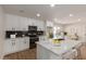 Modern kitchen featuring white cabinets, quartz countertops, stainless steel appliances, and a stylish backsplash at 6607 S Mitchell Dr, Tempe, AZ 85283