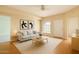 Bright living room features neutral decor, a large window, and modern furnishings for a cozy, inviting space at 8140 N 107Th Ave # 107, Peoria, AZ 85345