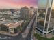 Aerial view of an urban area featuring modern buildings, light rail, and lush landscaping at 1 E Lexington Ave # 1302, Phoenix, AZ 85012