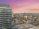 Scenic aerial view of the city with desert mountains in the background at sunset at 1 E Lexington Ave # 1302, Phoenix, AZ 85012
