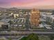 Stunning aerial view of high-rise community with city views and desert mountain backdrop at sunset at 1 E Lexington Ave # 1302, Phoenix, AZ 85012