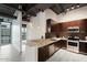 Stylish kitchen featuring stainless steel appliances, rich wood cabinetry, and a mosaic backsplash at 1 E Lexington Ave # 1302, Phoenix, AZ 85012