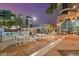 Well-appointed patio with dining tables and chairs near the community pool at 1 E Lexington Ave # 1302, Phoenix, AZ 85012