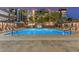 Beautiful community swimming pool with lounge chairs and well-lit surroundings at 1 E Lexington Ave # 1302, Phoenix, AZ 85012