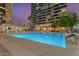 Inviting community swimming pool with lounge area and lush landscaping at 1 E Lexington Ave # 1302, Phoenix, AZ 85012