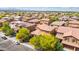 Aerial view of a neighborhood featuring well-maintained homes with tile roofs, landscaping, and community streets at 12172 W Davis Ln, Avondale, AZ 85323