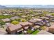 Beautiful aerial view of a neighborhood with lush landscaping, fenced yards, and scenic mountain views at 12172 W Davis Ln, Avondale, AZ 85323