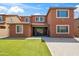 Large backyard with well-manicured artificial turf and patio with wrought iron furniture set at 12172 W Davis Ln, Avondale, AZ 85323