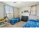 Shared bedroom with two beds, neutral tones, and themed decor at 12172 W Davis Ln, Avondale, AZ 85323