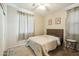 Cozy bedroom with neutral tones, a comfortable bed, and natural light from the window at 12172 W Davis Ln, Avondale, AZ 85323