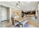 A well-lit dining area offers a spacious table, modern lighting, and comfortable bench seating at 12172 W Davis Ln, Avondale, AZ 85323