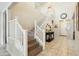 Bright and inviting entryway with staircase and decorative console table at 12172 W Davis Ln, Avondale, AZ 85323