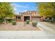 Charming two-story home featuring a stone facade, two-car garage, and professionally landscaped front yard at 12172 W Davis Ln, Avondale, AZ 85323