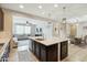 Open kitchen layout connects to the living and dining areas, with a center island and dark wood cabinetry at 12172 W Davis Ln, Avondale, AZ 85323