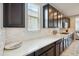 Kitchen features quartz countertops, dark wood cabinets, and a stylish tile backsplash at 12172 W Davis Ln, Avondale, AZ 85323