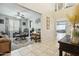 View of a open floor plan living room with tile flooring, ornate furniture, decor, ceiling fan, and a view of the dining area at 12172 W Davis Ln, Avondale, AZ 85323