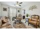 Inviting living room featuring a ceiling fan, ornate furniture, decor and an area rug on the tile floor at 12172 W Davis Ln, Avondale, AZ 85323