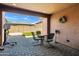 Cozy outdoor patio featuring tile flooring, recessed lighting, and a wrought iron furniture set at 12172 W Davis Ln, Avondale, AZ 85323