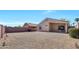 Low-maintenance backyard with desert landscaping, privacy fence, and a covered patio area at 12469 W Hearn Rd, El Mirage, AZ 85335