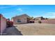 Expansive backyard with drought-tolerant landscaping, privacy fence, and well-maintained exterior at 12469 W Hearn Rd, El Mirage, AZ 85335
