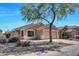 Charming single-story home featuring a well-manicured front yard and an attached two-car garage at 12469 W Hearn Rd, El Mirage, AZ 85335