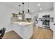 Modern kitchen with stainless steel appliances, quartz countertops, and ample cabinet space at 12469 W Hearn Rd, El Mirage, AZ 85335