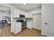 Modern kitchen featuring stainless steel appliances, white cabinets, and hardwood flooring at 12469 W Hearn Rd, El Mirage, AZ 85335