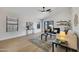 Bright living room featuring vaulted ceiling, wood floors, contemporary furnishings, and backyard access at 12469 W Hearn Rd, El Mirage, AZ 85335