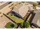 The home, its backyard, patio with a hot tub, garden, and pristine lawn as seen from an aerial view at 13806 W Remuda Dr, Peoria, AZ 85383