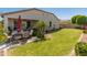 Well-maintained backyard featuring a covered patio with a dining set and lush greenery at 13806 W Remuda Dr, Peoria, AZ 85383
