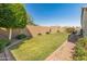 Spacious backyard featuring a well-manicured lawn and privacy fence for outdoor recreation and relaxation at 13806 W Remuda Dr, Peoria, AZ 85383