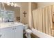 Charming bathroom featuring a white vanity, tile flooring, and a shower with neutral curtain at 13806 W Remuda Dr, Peoria, AZ 85383