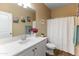 Bathroom with double sinks, white vanity and tiled floors at 13806 W Remuda Dr, Peoria, AZ 85383