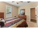 Comfortable bedroom featuring wood dresser, a window with shutters, and neutral colored walls at 13806 W Remuda Dr, Peoria, AZ 85383
