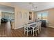 Inviting dining room featuring decorative wood flooring, wooden table, and an elegant light fixture at 13806 W Remuda Dr, Peoria, AZ 85383